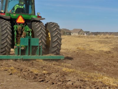 Tractor prepares soil for native grass seeding